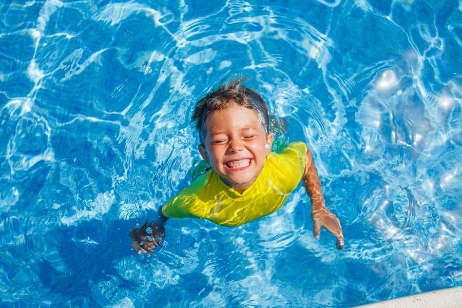 A young swimmer moving across a pool